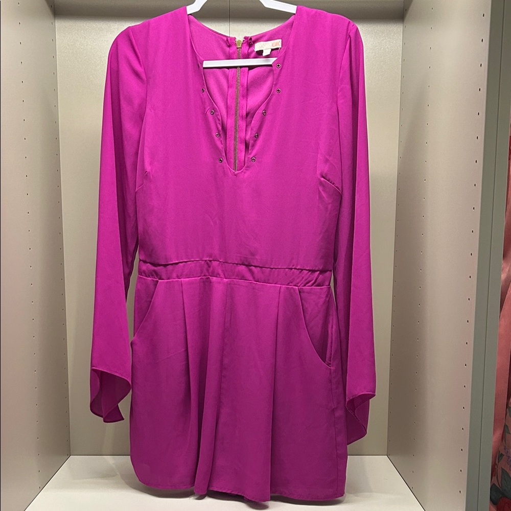 Fuchsia Grommet neckline long sleeve romper by Gianni Bini